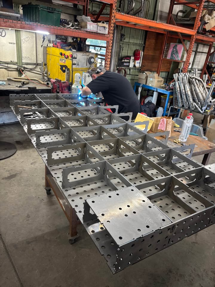 Exposed tab-and-slot rib and stiffener matrix beneath a Datum fixture table top