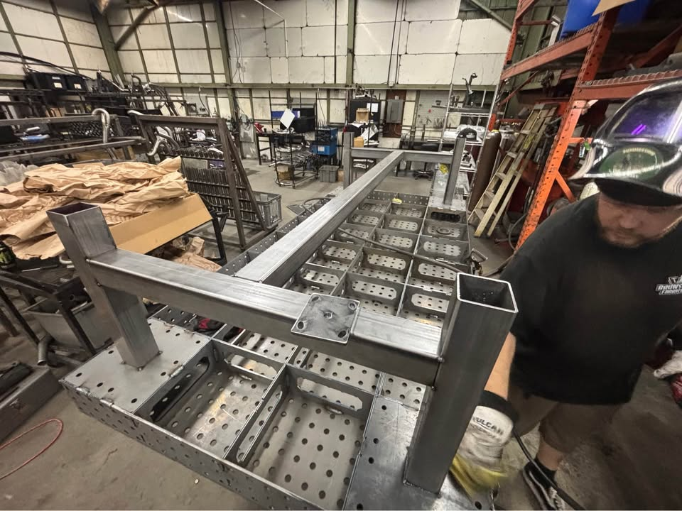 Datum fixture table upside down while its welded leg structure is assembled over the internal rib matrix