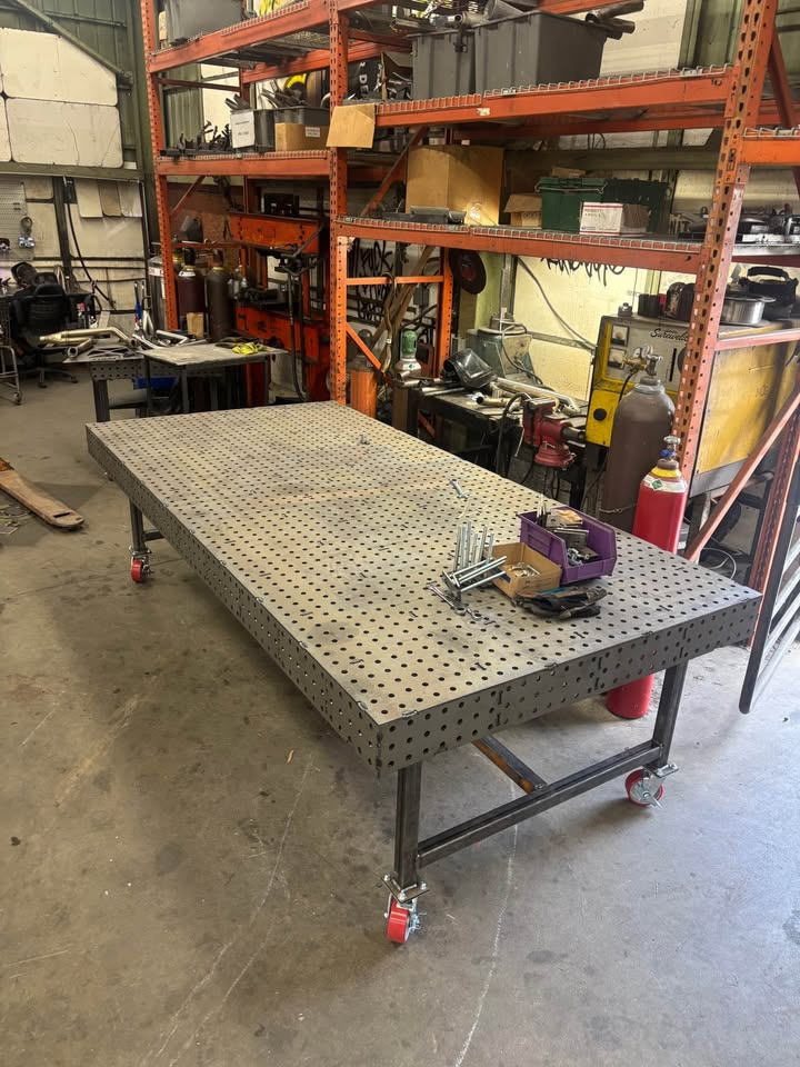 Finished steel Datum welding fixture table on locking casters in a working fabrication shop